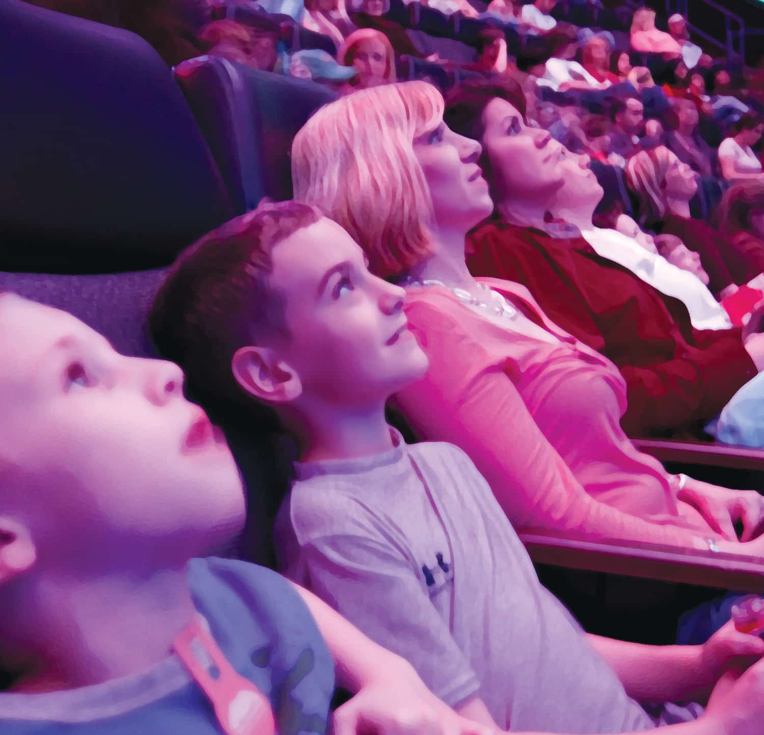 a group of people sitting in front of a crowd