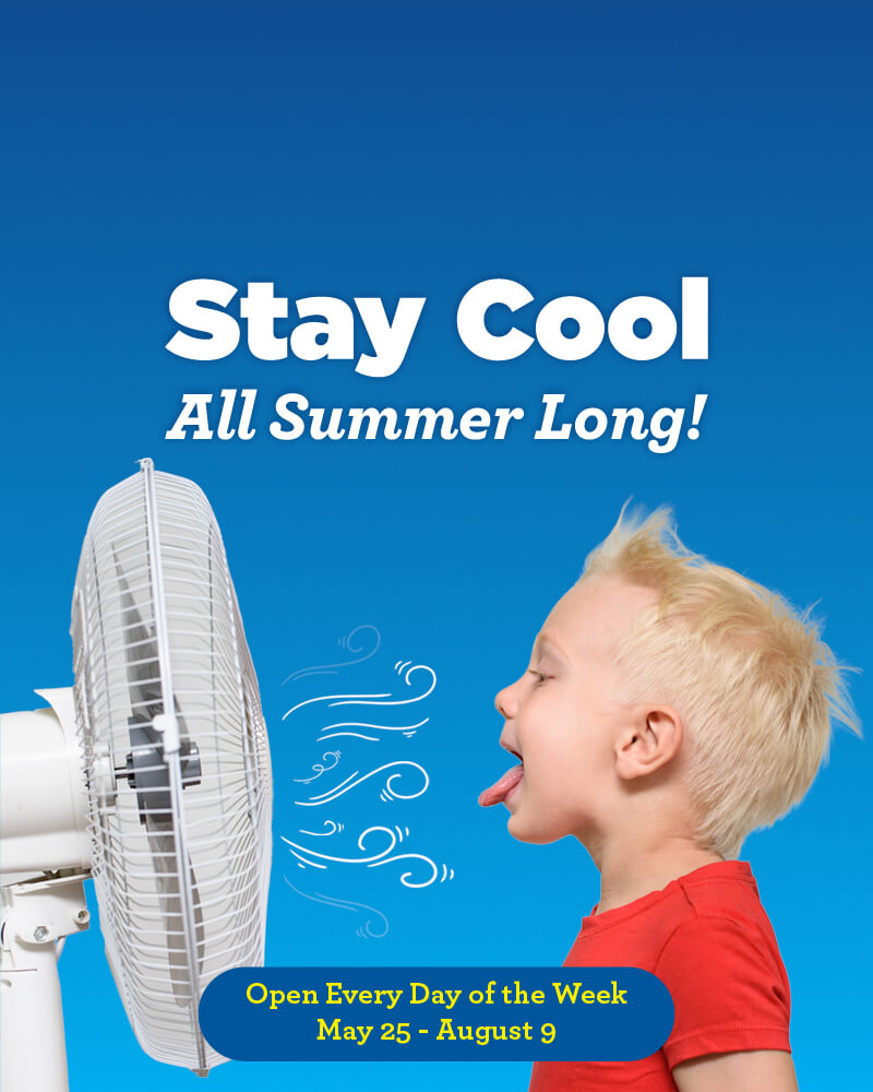 Child enjoys a fan at the children’s science center—stay cool all summer; open daily May 25–Aug 9.